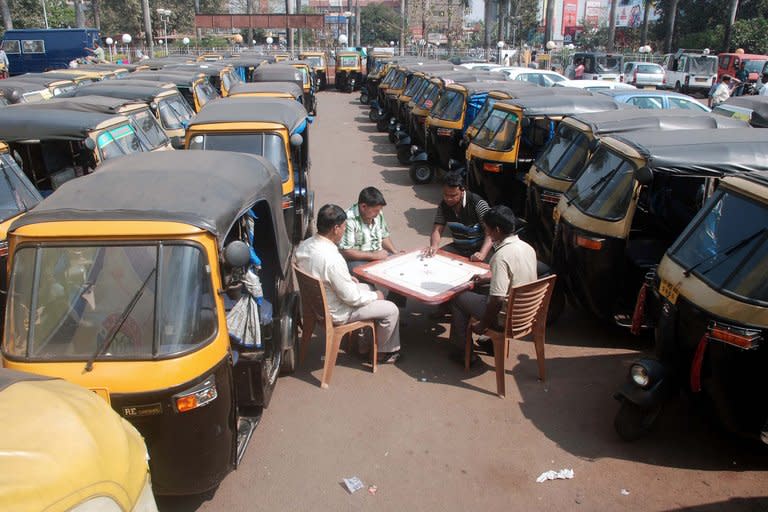 Striking Indian auto-rickshaw drivers play carrom amid their vehicles at an auto stand during a two-day strike called by trade unions opposing the government’s economic policies in Bhubaneswar on February 20, 2013. Financial services and transport were hit by the strike called by 11 major workers' groups to protest against pro-market economic reforms announced by the government last year