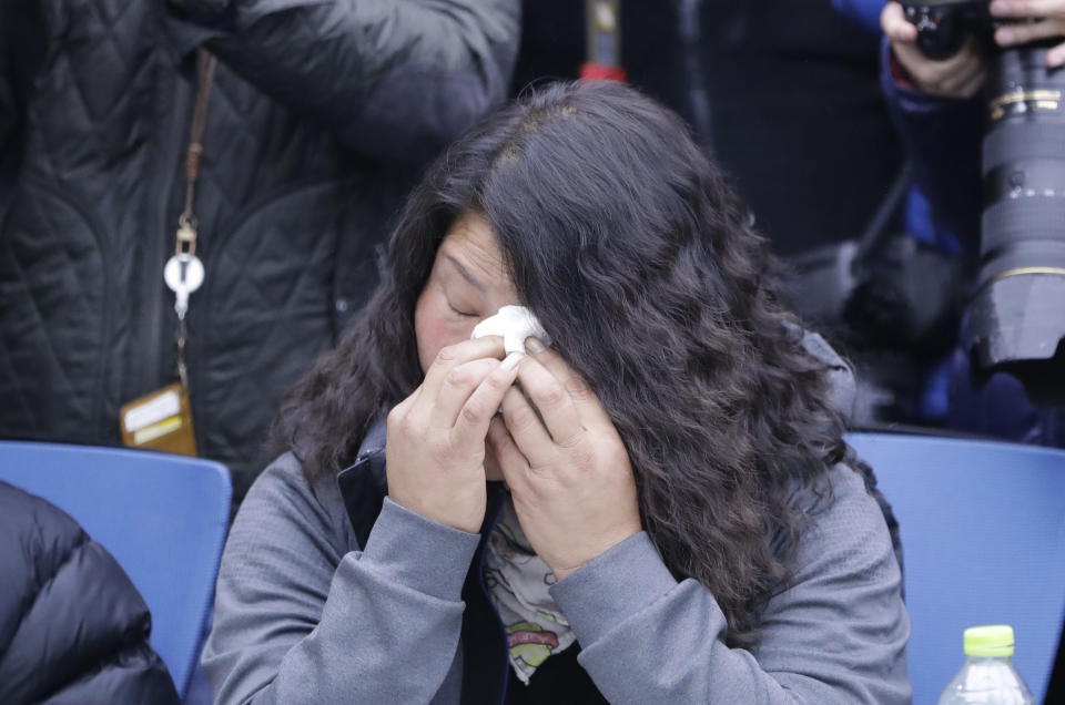 South Korean Park Sun-yi, who spent more than five years at Brothers Home after being snatched by police at the age of 9, wipes away tears as she listens to South Korea's Prosecutor General Moon Moo-il speaks during a meeting with about a dozen former inmates in Seoul, South Korea, Tuesday, Nov. 27, 2018. South Korea's top public prosecutor on Tuesday apologized over what he described as a botched investigation into the enslavement and mistreatment of thousands of people at a vagrants' facility in the 1970s and 1980s nearly three decades after its owner was acquitted of serious charges. (AP Photo/Lee Jin-man)