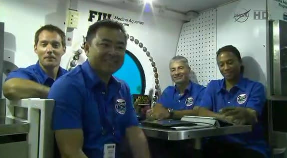 The NEEMO 18 crew participates in a news conference from the Aquarius underwater lab, just off the coast of Key Largo, Florida. From left, European Space Agency astronaut Thomas Pesquet, Japanese astronaut Akihiko Hoshide and NASA astronauts Ma