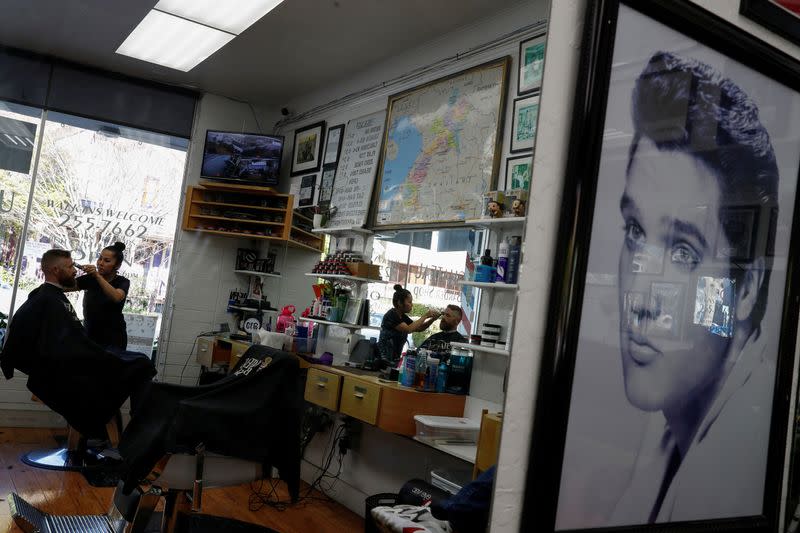 FILE PHOTO: Resident gets a haircut at the Chateau Barber Shop, prior to California Governor Gavin Newsom's effective immediately statewide shelter-in-place order, in the face of the fast-spreading coronavirus disease (COVID-19), in Napa, CA