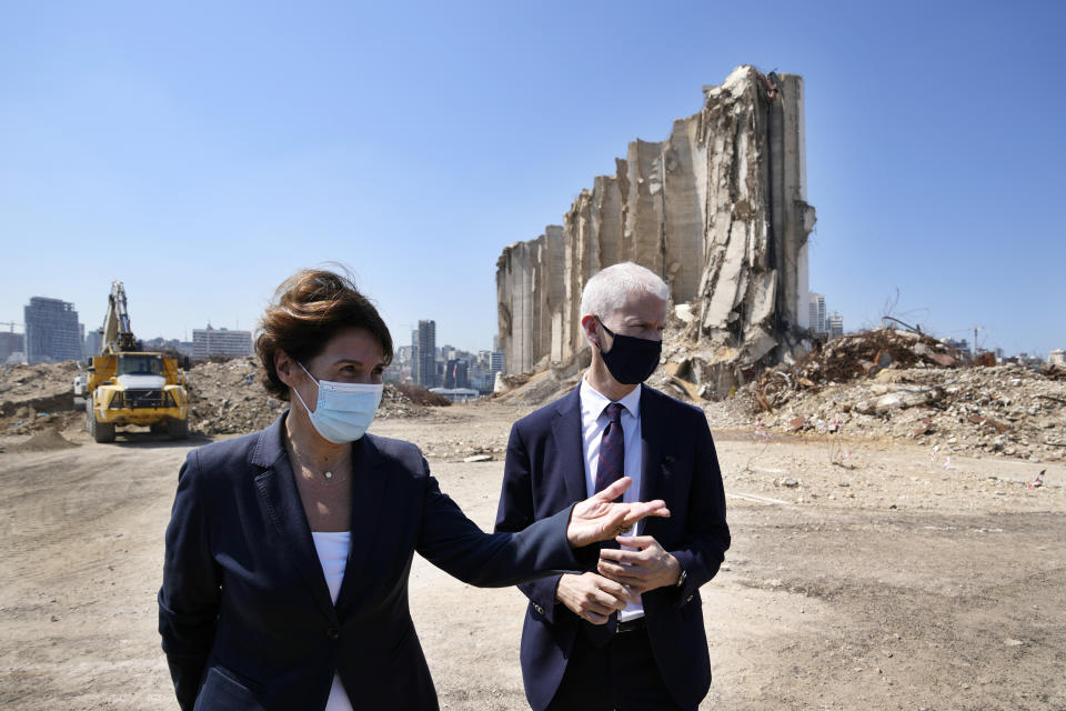 French Foreign Trade Minister Franck Riester, right and the French Ambassador to Lebanon Anne Grillo, visit Beirut's port, devastated in a massive deadly explosion in August last year, in Beirut, Lebanon, Tuesday, July 13, 2021. Riestert criticized Lebanese leaders on Tuesday, warning them of upcoming sanctions from Paris that will target Lebanese officials blocking the formation of a new government. (AP Photo/Hassan Ammar)