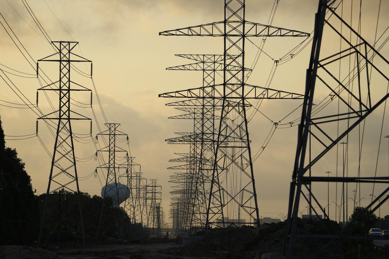 The sun rises over power lines in Houston.