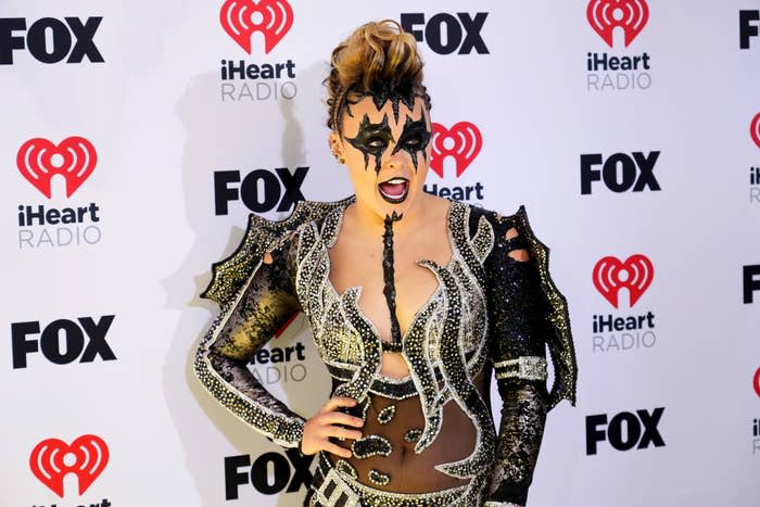 Lady Gaga in an ornate outfit with bold shoulder accents and face paint at an event