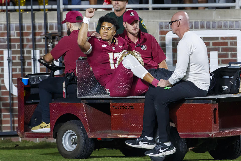 Florida State quarterback Jordan Travis is taken off the field after being injured during the first half of the team's NCAA college football game against North Alabama, Saturday, Nov. 18, 2023, in Tallahassee, Fla. (AP Photo/Colin Hackley)