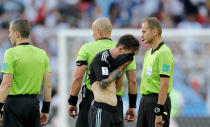 <p>Argentina’s Lionel Messi covers his face at the end of the group D match </p>