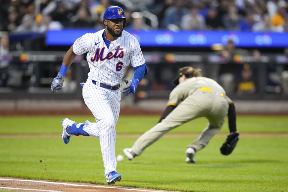 New York Mets' Starling Marte (6) runs past San Diego Padres starting pitcher Ryan Weathers after bunting for a single during the first inning of a baseball game Tuesday, April 11, 2023, in New York. (AP Photo/Frank Franklin II)