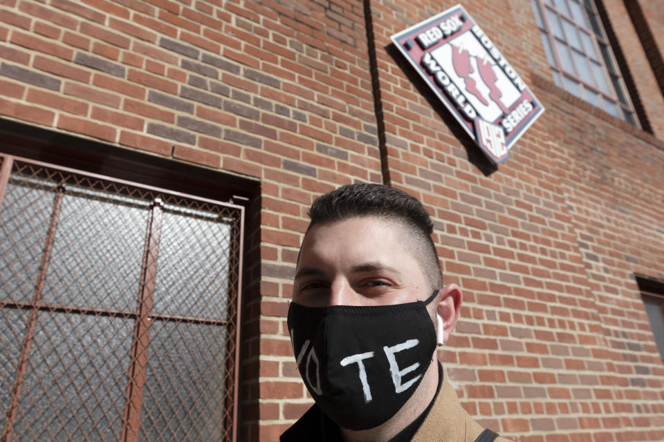 Nick Diamond waits in line to vote at Fenway Park, Saturday, Oct. 17, 2020, in Boston. (AP Photo/Michael Dwyer)