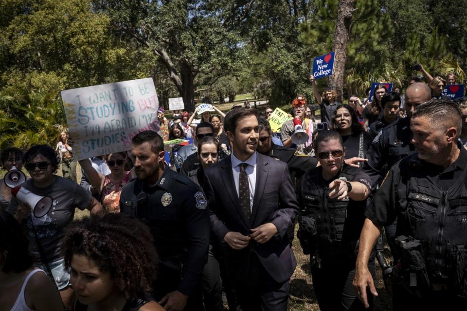 <div class="inline-image__caption"><p>Christopher Rufo, a conservative activist and New College of Florida trustee, walks through protestors on his way out of a bill signing event featuring Florida Governor Ron DeSantis, who signed three education bills on the campus of New College of Florida in Sarasota, Fla. on May 15, 2023.</p></div> <div class="inline-image__credit">Thomas Simonetti for The Washington Post via Getty Images</div>
