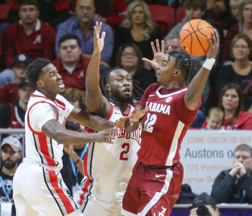 Ohio State's Dale Bonner left, and Roddy Gayle Jr. pressure Alabama's Jarin Stevenson during the first half of an NCAA college basketball game Friday, Nov. 24, 2023, in Niceville, Fla. (AP Photo/Michael Snyder)