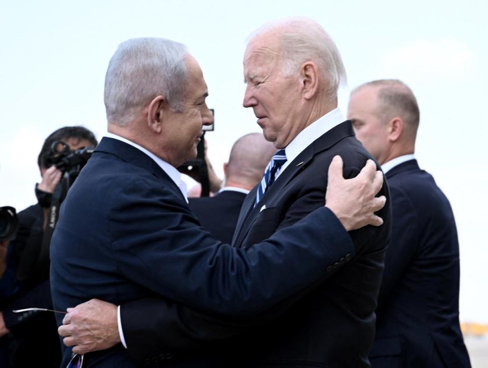 Israel Prime Minister Benjamin Netanyahu greets US President Joe Biden upon his arrival at Tel Aviv’s Ben Gurion airport on 18 October 2023 (AFP via Getty Images)