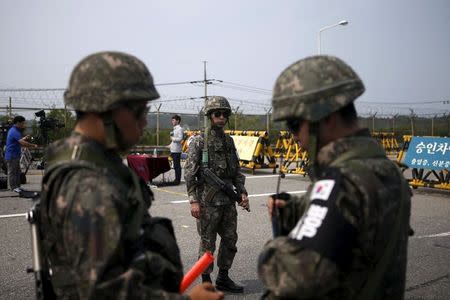 South Korean soldiers stand guard at a checkpoint on the Grand Unification Bridge which leads to the truce village Panmunjom, just south of the demilitarized zone separating the two Koreas, in Paju, South Korea, August 24, 2015. REUTERS/Kim Hong-Ji