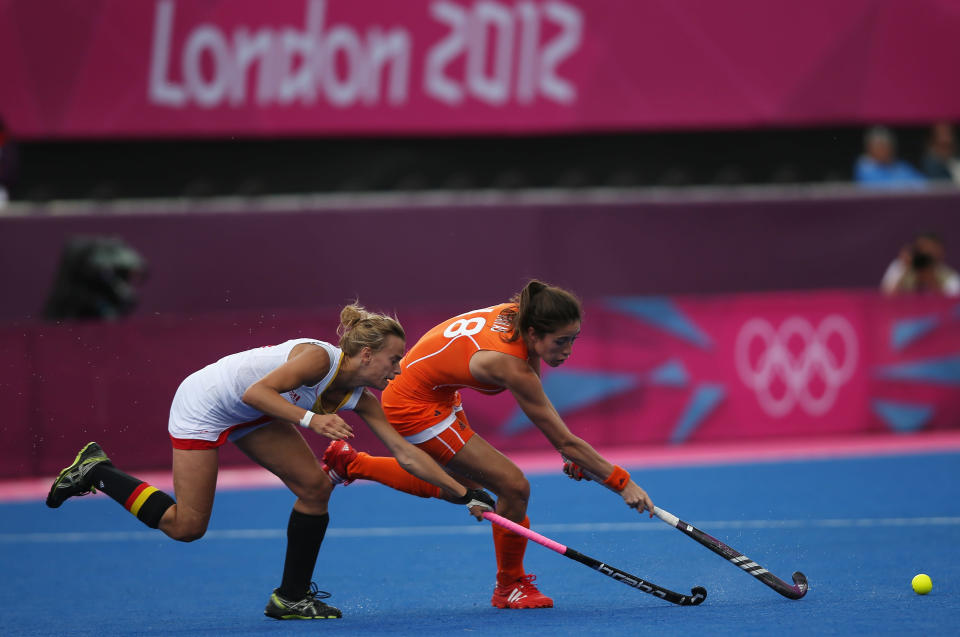 LONDON, ENGLAND - JULY 29: Naomi Van As of Netherlands competes with Charlotte de Vos of Belgium during the Women's Pool WA Match W02 between the Netherlands and Belgium at the Hockey Centre on July 29, 2012 in London, England. (Photo by Daniel Berehulak/Getty Images)