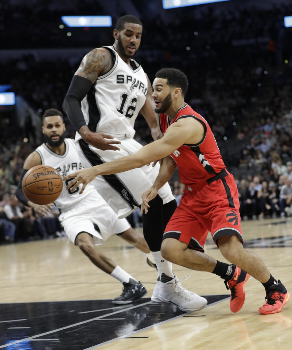 Toronto Raptors guard Cory Joseph (6) drives around San Antonio Spurs forward LaMarcus Aldridge (12) during the first half of an NBA basketball game, Tuesday, Jan. 3, 2017, in San Antonio. (AP Photo/Eric Gay)