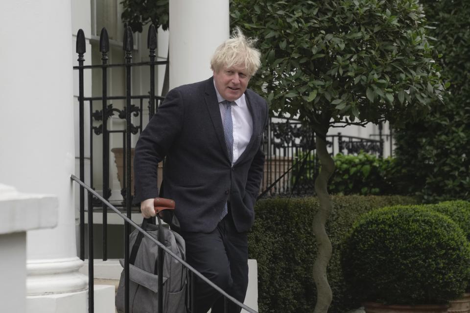 Former British Prime Minister Boris Johnson leaves his home, in London, Tuesday, March 21, 2023. (AP Photo/Kin Cheung)