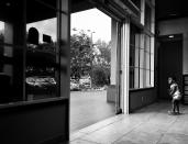 <p>A young girl peers at the door of a sold-out Best Western in Naples, Fla., a hotel that kept operating even though it lost power during Hurricane Irma. (Photo: Holly Bailey/Yahoo News) </p>