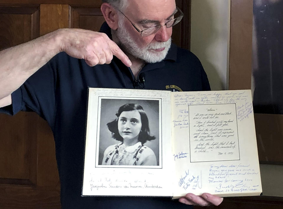 In this June 7, 2019 photo, Ryan Cooper holds a 1972 portion of a diary that he wrote when he visited Otto Frank, the father of the famed Holocaust victim and diarist Anne Frank, at his home in Yarmouth, Mass. The diary includes a photo of Anne Frank and the autographs of other people he met who knew her. Cooper has donated a trove of letters and mementos he received from Otto Frank to the U.S. Holocaust Memorial Museum ahead of the 90th anniversary of Anne Frank's birthday. (AP Photo/Philip Marcelo)