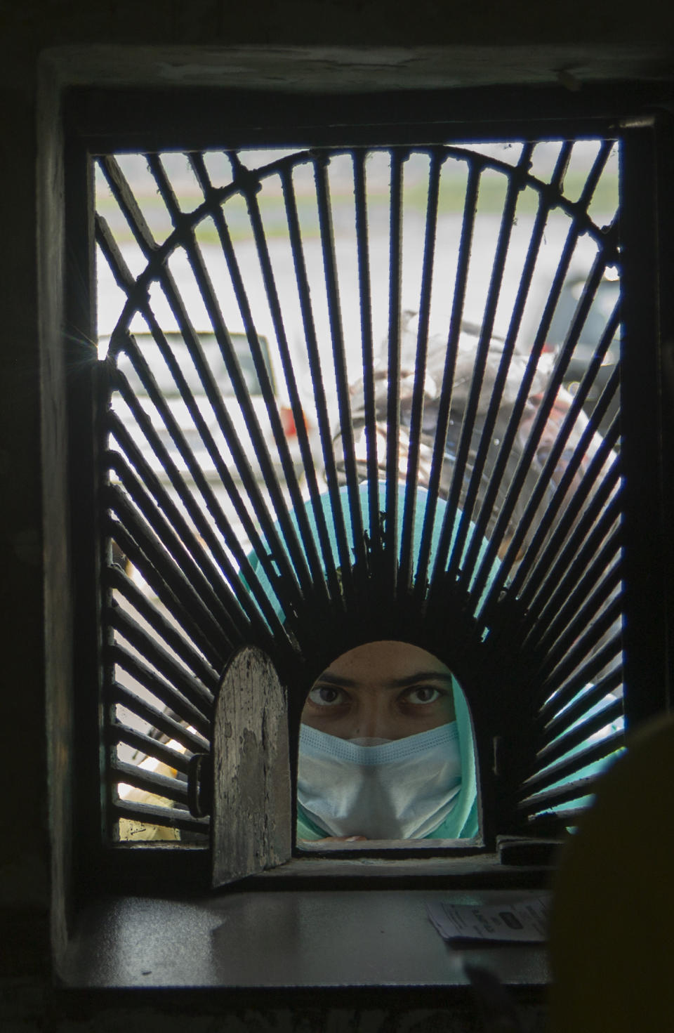 A local visitor waits for tickets outside Mughal Garden on the outskirts of Srinagar, Indian controlled Kashmir, Wednesday, July 8, 2020. After four months of lockdown to control the spread of the coronavirus, officials in Indian administered Kashmir Wednesday ordered reopening of the famous Mughal Garden and public parks across the valley although COVID-19 cases continue to rise in the region. (AP Photo/Mukhtar Khan)