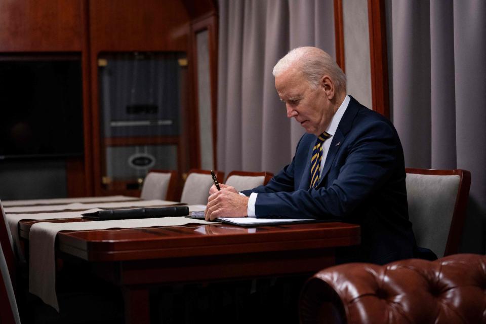 President Joe Biden sits on a train as he goes over his speech marking the one-year anniversary of the war in Ukraine after a surprise visit to meet with Ukrainian President Volodymyr Zelenskyy, in Kyiv on February 20, 2023.