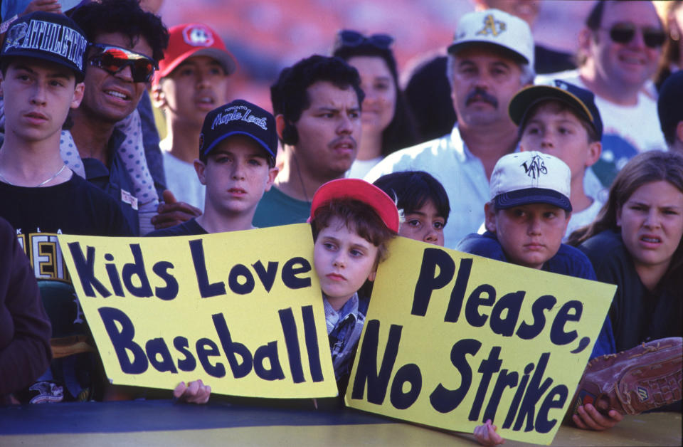 OAKLAND, CA - AUGUST 11:  (FILE PHOTO) Fans hold up signs in protest of the baseball strike on August 11, 1994 during a game between the Seattle Mariners and the Oakland Athletics at the Oakland Coliseum in Oakland, California. A senior member of the union's executive board said baseball players set a strike date for August 30, 2002.  The strike puts the sport on course for its ninth work stoppage since 1972.  (Photo by Otto Greule/Getty Images)