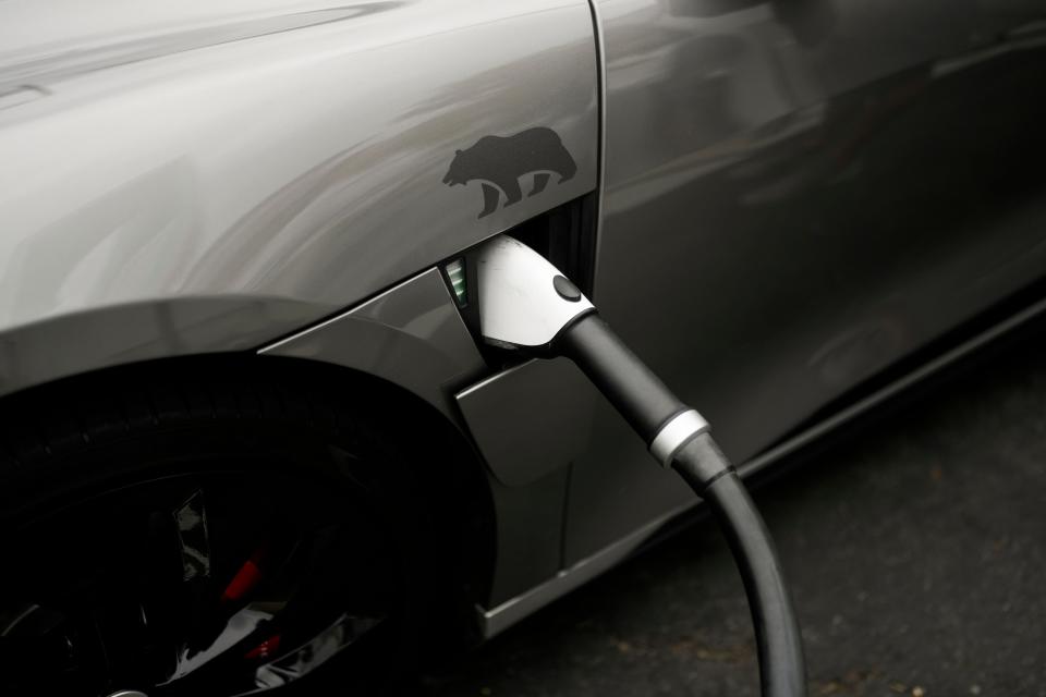 A Combined Charging System connector is plugged into an electric vehicle at a charging station, June 9, 2023, in Anaheim, Calif.