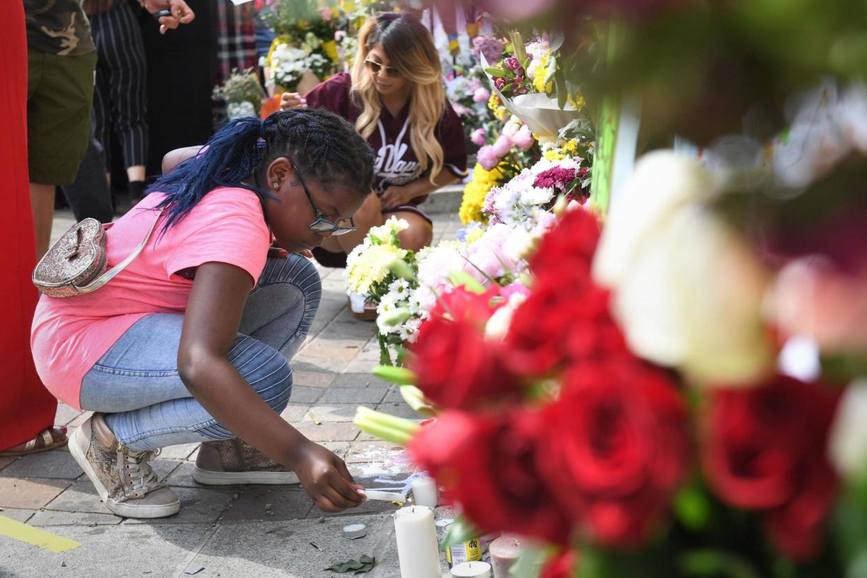 Young children lay floral tributes for the victims of the blaze: PA Wire/PA Images