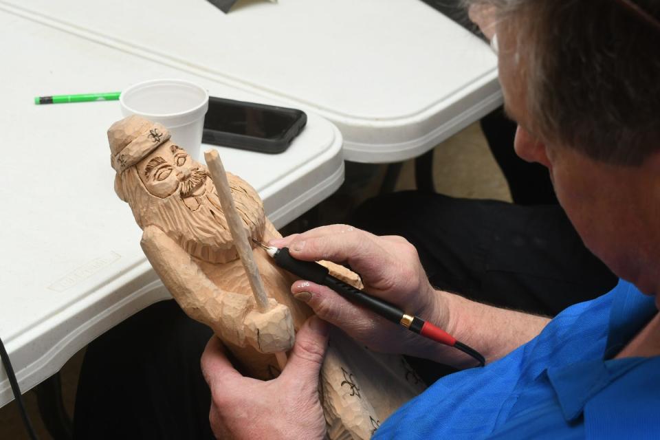 John Wilks Jr., carve a caricature at a meeting of The Wood Artisan Guild of the Cenla. He became interested in wood carving in 1994 after he saw a woodcarver by the name of Jerry Finley and took some of his classes.