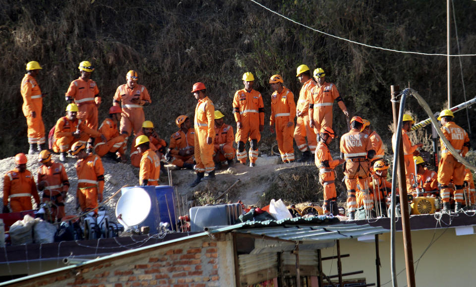 Rescuers rest at the site of an under-construction road tunnel that collapsed in Silkyara in the northern Indian state of Uttarakhand, Friday, Nov. 24, 2023. Rescuers are racing to evacuate 41 construction workers who have been trapped for nearly two weeks. (AP Photo)