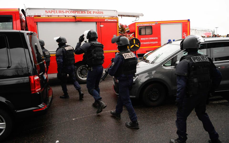 French policemen and firefighters secure the area at Paris' Orly airport  - Credit: AFP/Getty Images