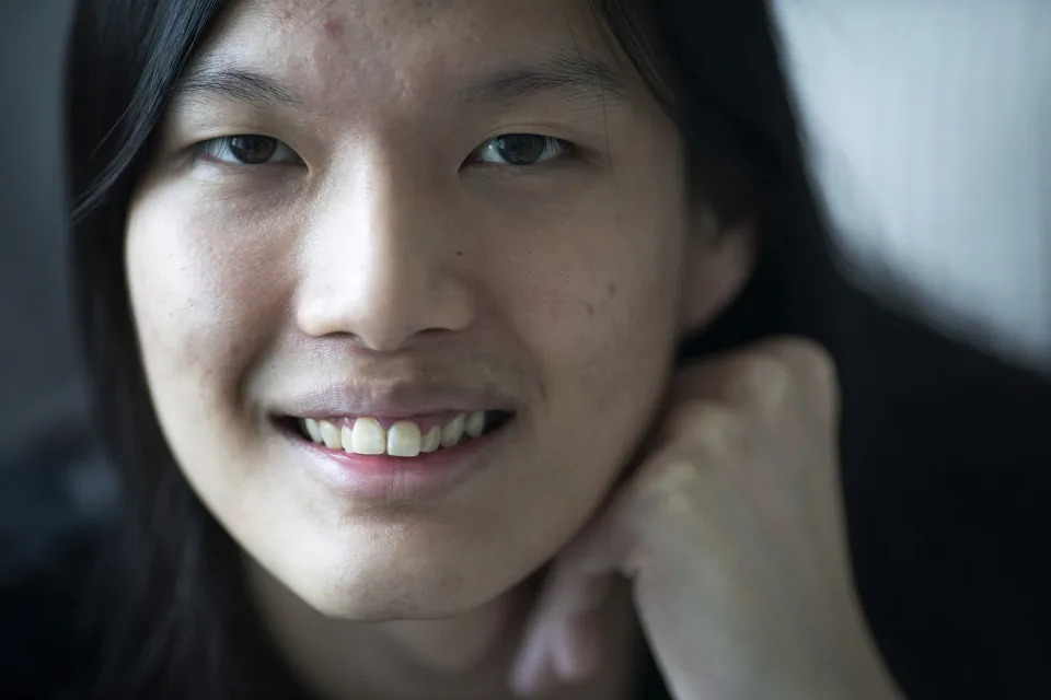 Lune Loh, 25, a transgender woman, poses for a portrait in her home in Singapore, on Friday, Aug. 19, 2022. She was raised as a boy by a protective mother and a conservative, stern father she grew to fear. Though he socialized Loh to be masculine, she knew early on that her body did not match who she was. Her first realization -- or flash point -- that something was off came one night at age 8, when she caught her distorted reflection in a window and suddenly imagined herself with long hair. (AP Photo/Wong Maye-E)