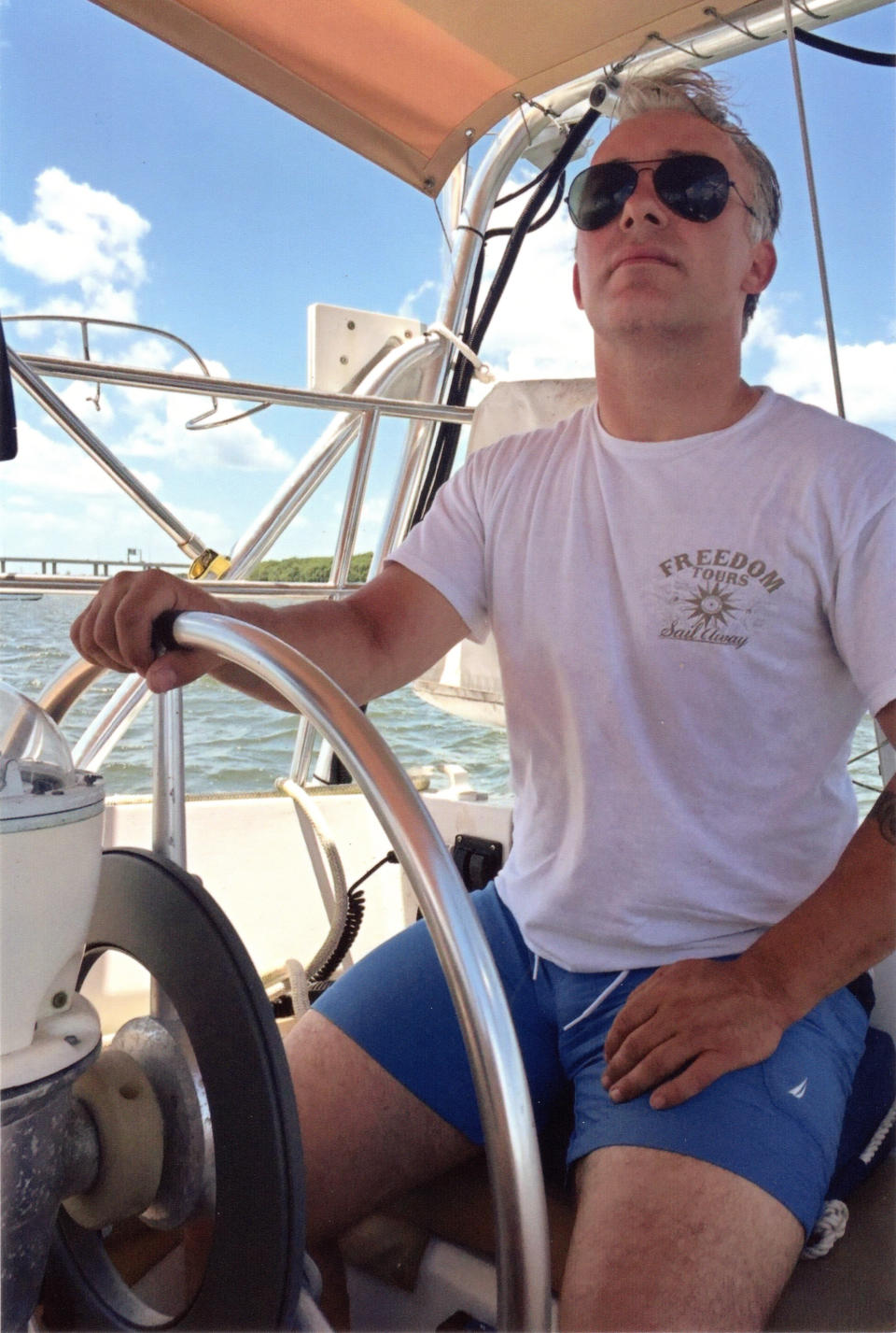 In this undated photo courtesy of the Heath family, Matthew Heath navigates a boat near the Florida Keys. Heath's family says he kept a boat in Key West, Florida with the hope it would be his ticket to a new career on the water and free of the toils of private security work he had been doing for more than a decade. (Heath family via AP)