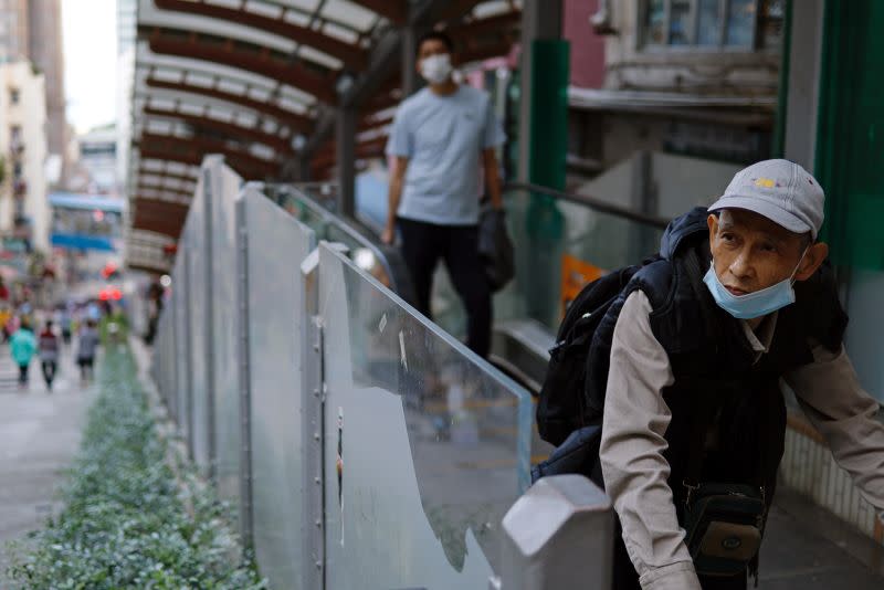 People wear masks following the coronavirus disease (COVID-19) outbreak, at the financial Central district in Hong Kong