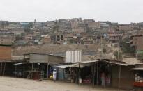 FILE PHOTO - A view of the marketplace and homes of Gosen City, a slum in the Villa Maria del Triunfo municipality on the outskirts of Lima, March 17, 2014. REUTERS/Mariana Bazo