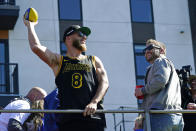 Los Angeles Rams wide receiver Cooper Kupp, left, holds a football as head coach Sean McVay, right, looks on as they ride on a bus during the team's victory parade in Los Angeles, Wednesday, Feb. 16, 2022, following their win Sunday over the Cincinnati Bengals in the NFL Super Bowl 56 football game. (AP Photo/Marcio Jose Sanchez)