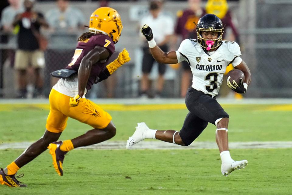 Colorado running back Dylan Edwards (3) tries to elude Arizona State defensive back Shamari Simmons (7) during the second half of an NCAA college football game Saturday, Oct. 7, 2023, in Tempe, Ariz. (AP Photo/Ross D. Franklin)