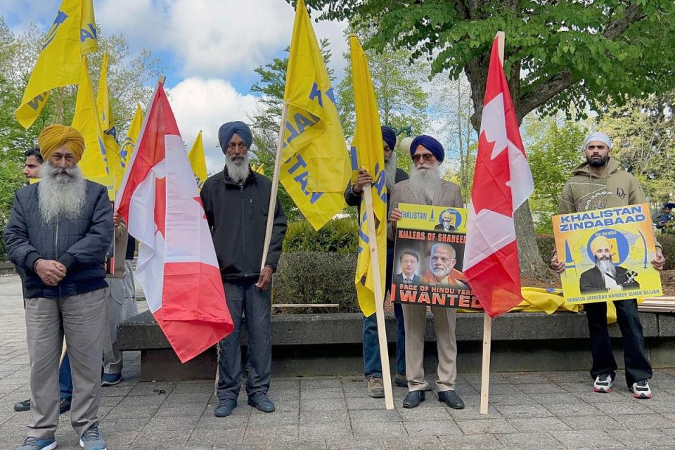 Members of British Columbia's Sikh community gather in front of the courthouse in Surrey, British Columbia on 7 May (AP)