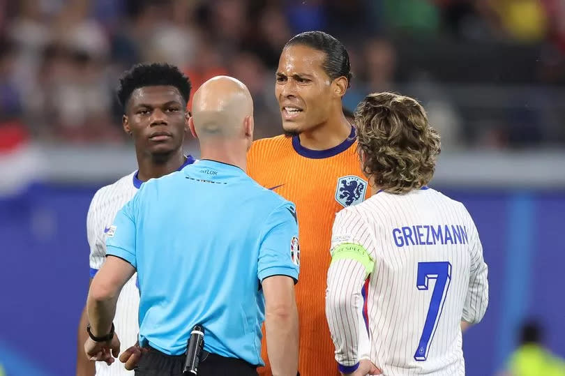 Virgil van Dijk interacts with Anthony Taylor at Euro 2024.