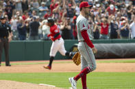 Los Angeles Angels starting pitcher Griffin Canning, foreground, walks from the mound after giving up a two-run home run to Cleveland Guardians' Jose Ramirez, rear, during the sixth inning of a baseball game in Cleveland, Sunday, May 5, 2024. (AP Photo/Phil Long)