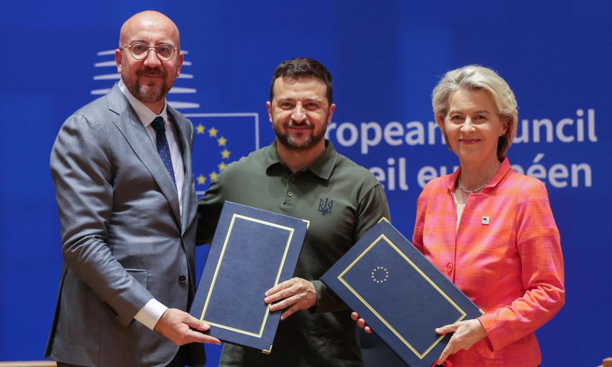 <span>Volodymyr Zelenskiy with the European Council president, Charles Michel, and the European Commission president, Ursula von der Leyen, after signing the security pact.</span><span>Photograph: Olivier Hoslet/Reuters</span>