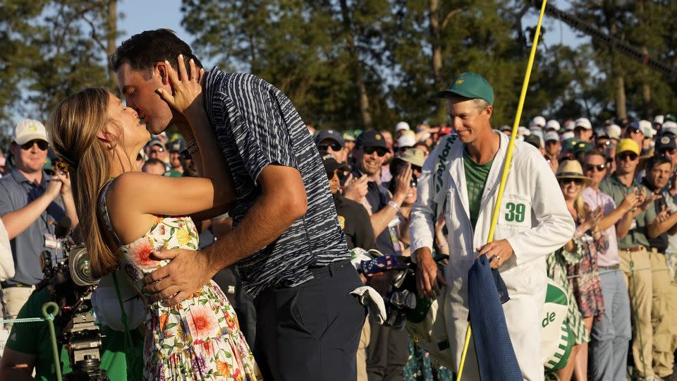 Scottie Scheffler kisses his wife, Meredith, after clinching his first Masters win. - David J. Phillip/AP