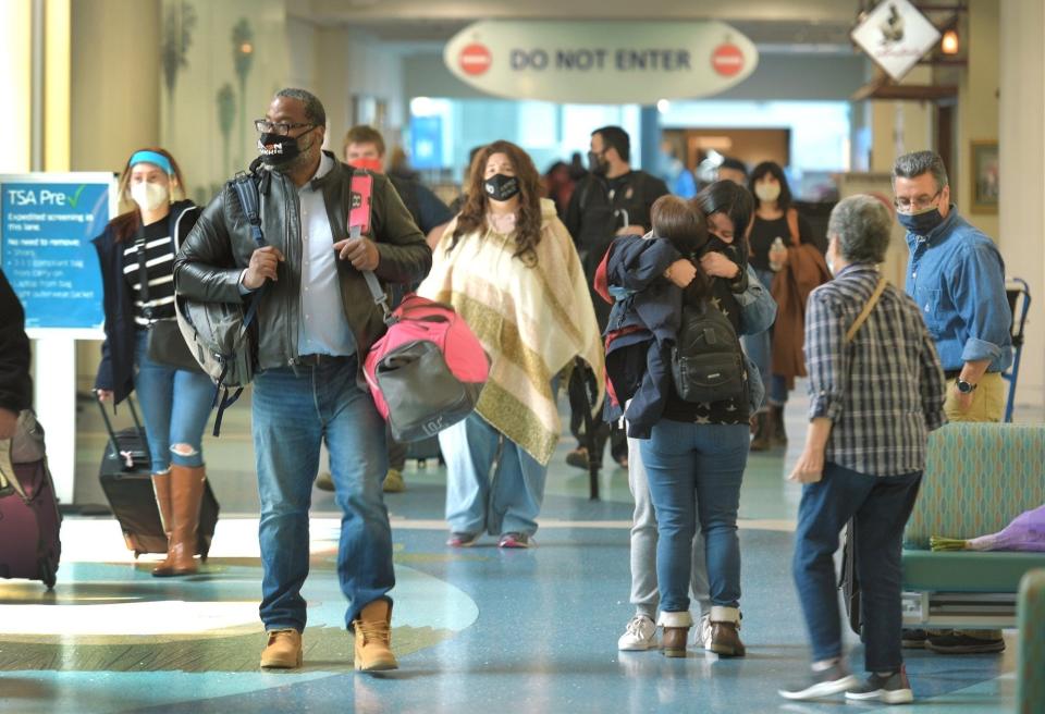 Travelers come and go at Jacksonville International Airport during a 2020 holiday rush.