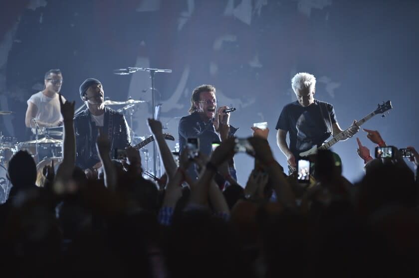 a band performing onstage in front of a crowd