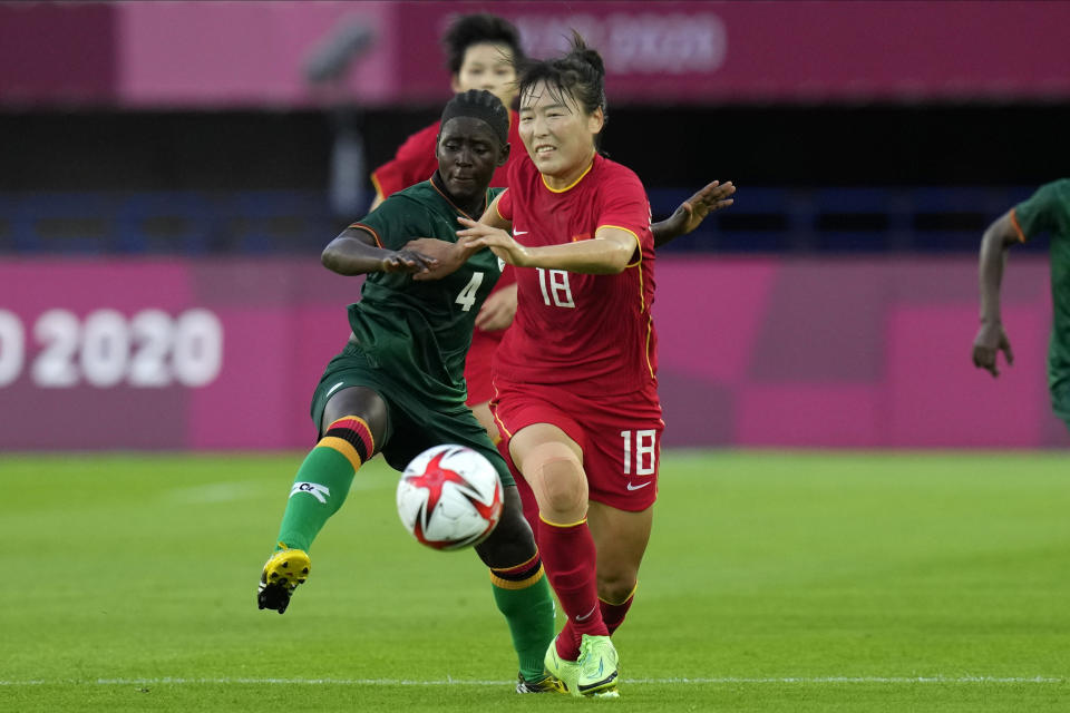 China's Wurigumula (18) and Zambia's Esther Siamfuko (4) battle for the ball during a women's soccer match at the 2020 Summer Olympics, Saturday, July 24, 2021, in Miyagi, Japan. (AP Photo/Andre Penner)