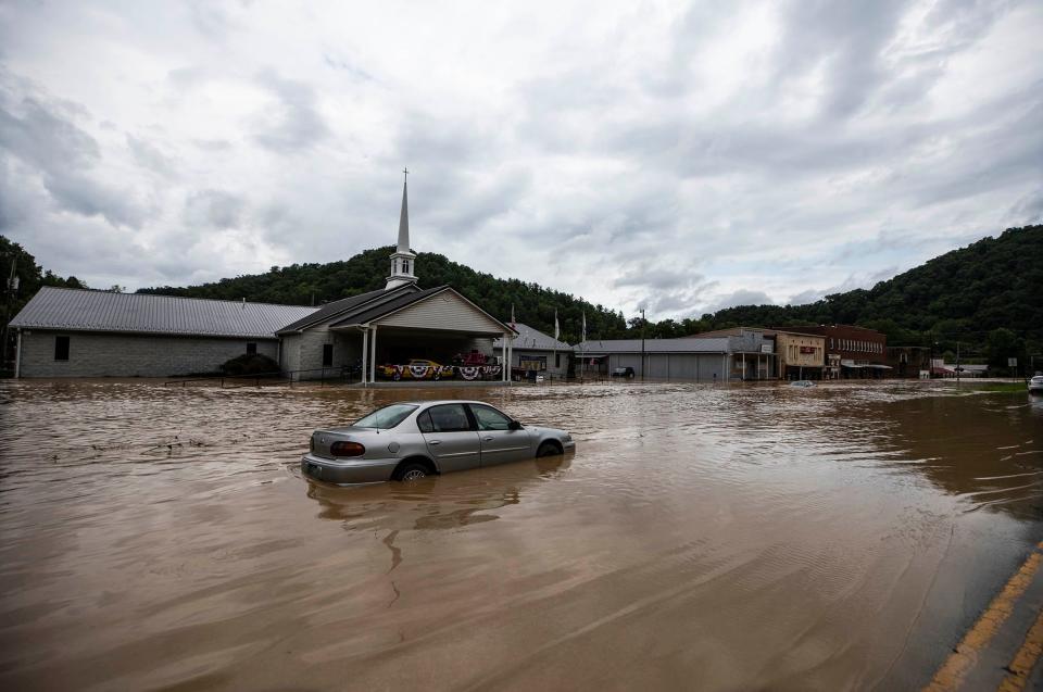 A car is submerged in flood waters along Right Beaver Creek, in Garrett, Kentucky, following a day of heavy rain. July 28, 2022