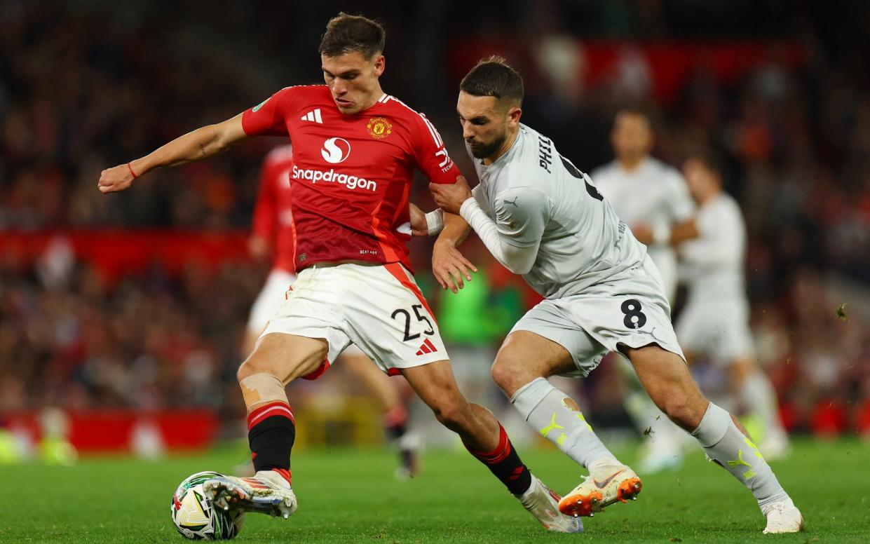 Manuel Ugarte playing for Manchester United against Barnsley