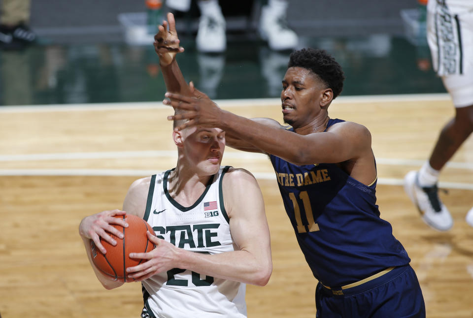 Michigan State's Joey Hauser, left, and Notre Dame's Juwan Durham vie for a rebound during the first half of an NCAA college basketball game, Saturday, Nov. 28, 2020, in East Lansing, Mich. (AP Photo/Al Goldis)