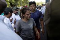 Migrants board a bus that will drive them to a shelter near Frontera Hidalgo