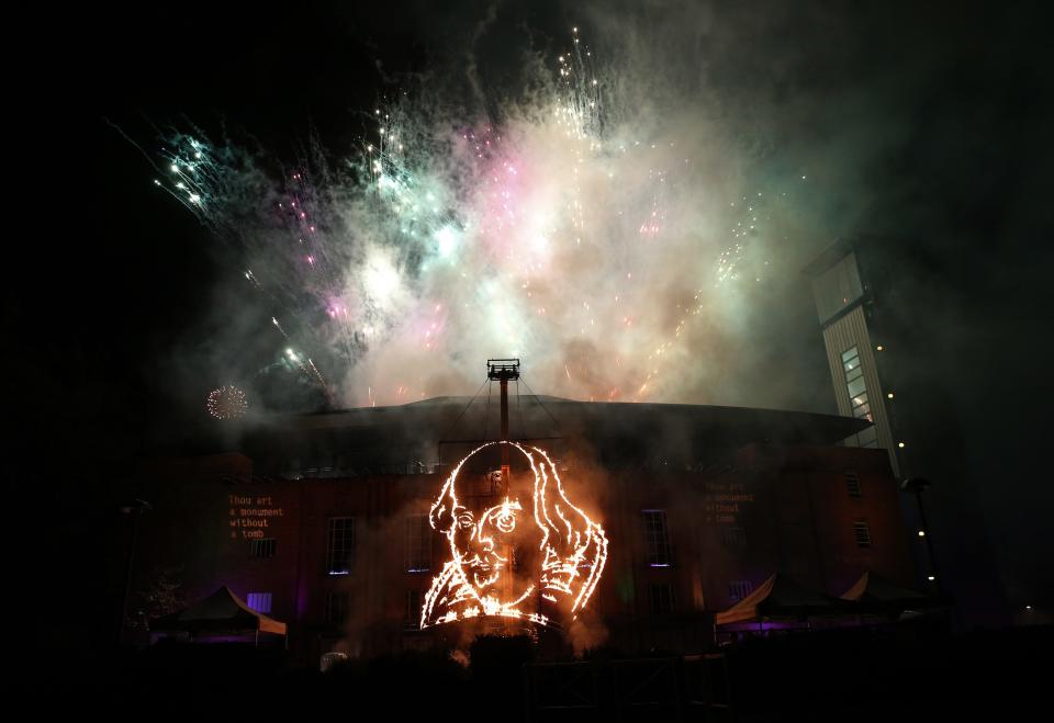 Fireworks go off over a flaming depiction of William Shakespeare during a firework display at the Royal Shakespeare Company marking the 450th anniversary of Shakespeare's birth in Stratford-upon-Avon