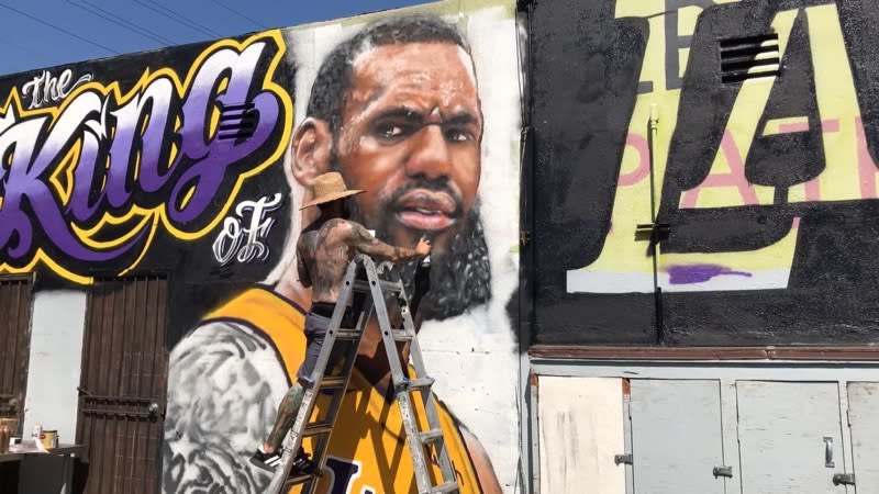 Muralist Jonas Never painting a tribute to LeBron James, which he covered up less than a week later due to vandalism. (Jonas Never)