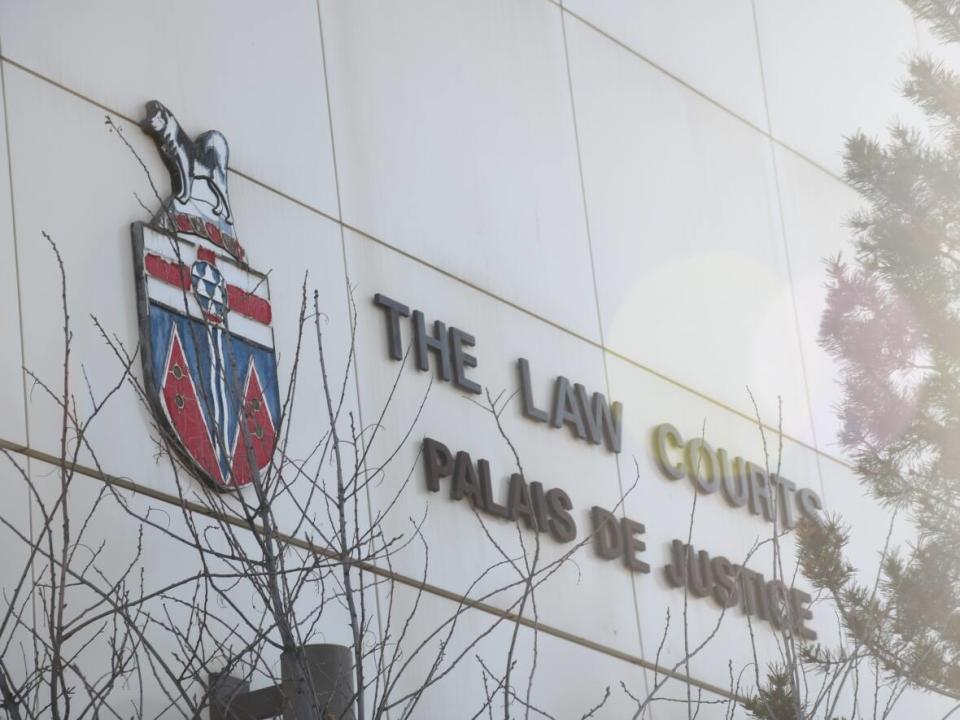 A close-up of the sign on the side of the courthouse in Whitehorse. (Jackie Hong/CBC - image credit)