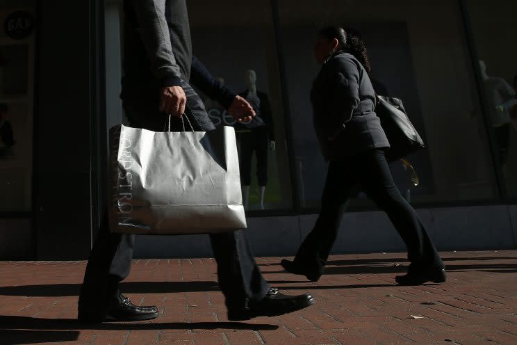 Man walking with shopping bag.